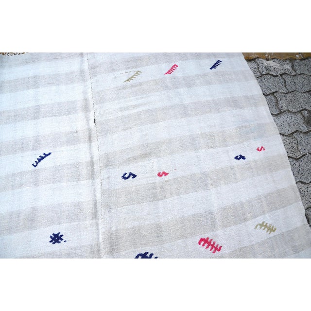 This is a vintage Turkish Anatolian kilim rug from the 1960s. The piece was hand-woven.