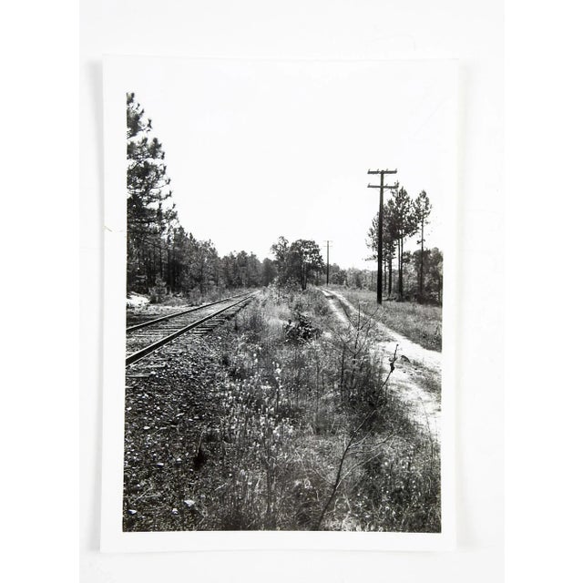 Circa 1980's photo of converging railroad and service road. Unsigned. Unframed.