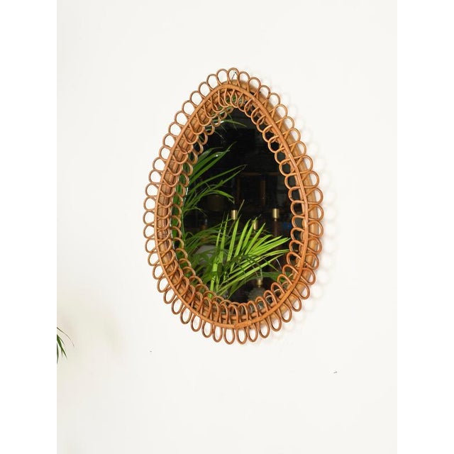 Outstanding French Riviera style teardrop-shaped mirror mirror fully hand-made in curved rattan and bamboo. This...