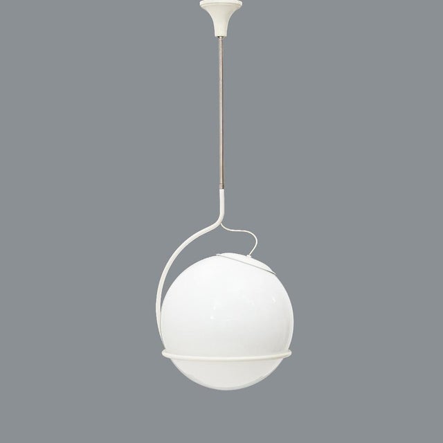 Italian-made chandelier produced in the 1970s. white painted metal rosette. chromed metal stem and white painted metal....