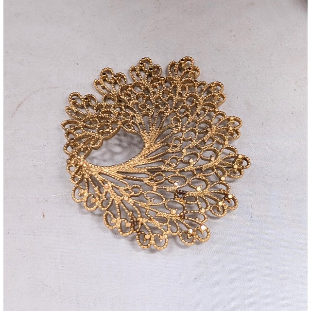 1966 goldtone filigree openwork brooch with security clasp. Marked "MONET©" on the back. Measure: 3 1/4 inches by 2 7/8...