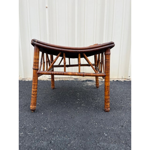 An early 20th century Egyptian Revival tortoise bamboo Thebes stool. Diagonally laid bamboo slats across a curved seat...