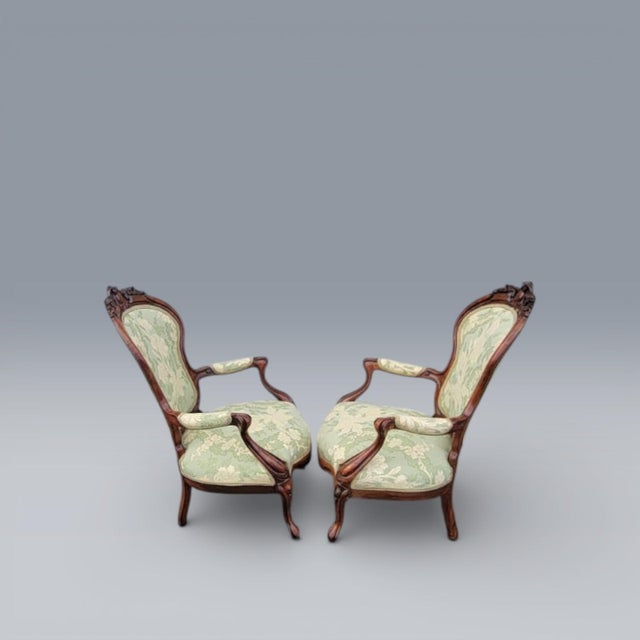 A beautiful pair of 19th Century American Victorian armchairs crafted from finely carved rosewood. These elegant chairs...