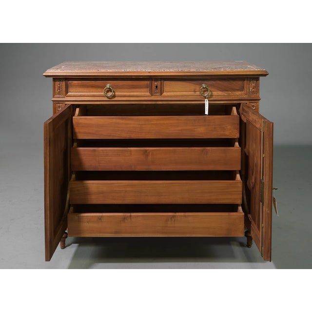 This exquisite sideboard showcases exceptional craftsmanship, featuring a richly carved walnut case adorned with elegant...