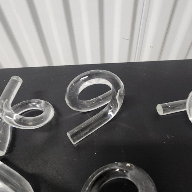 Add an artful touch to your table setting with this set of eight modern clear glass napkin rings. Each piece features a...