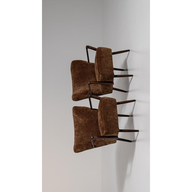 A brown wood, Mid-Century Modern-style armchair, dating to the 1940s and made in Denmark. The wood frame is finished in...