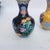 This is a vibrant, matching set of four small baluster-form vases, crafted in the traditional cloisonné enamel technique....