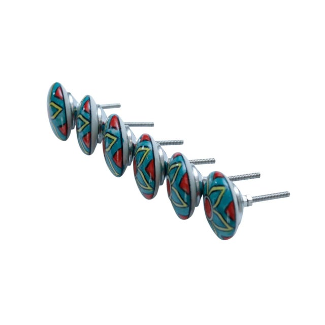 A set of six round ceramic knob handles. Hand painted with a simple Celtic style flower in yellow and white over a teal...