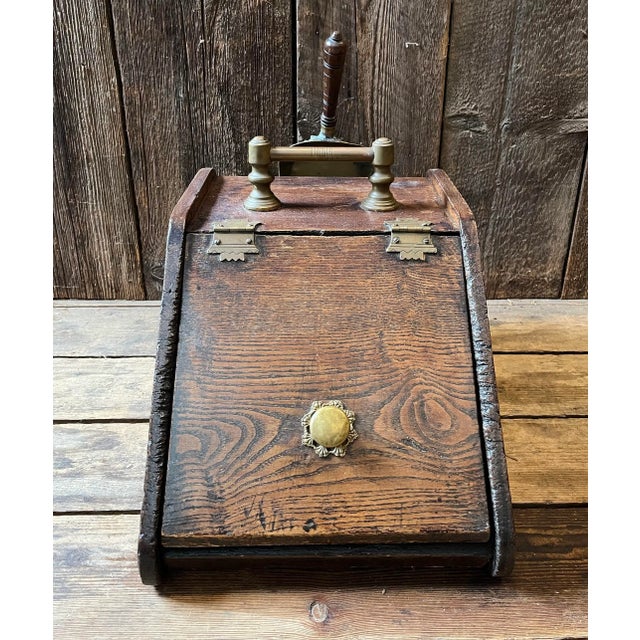 Antique English Coal Hod with a lift door and brass shovel. Dimensions: W: 12" x D: 16.75" x H: 13" ; Overall height with...