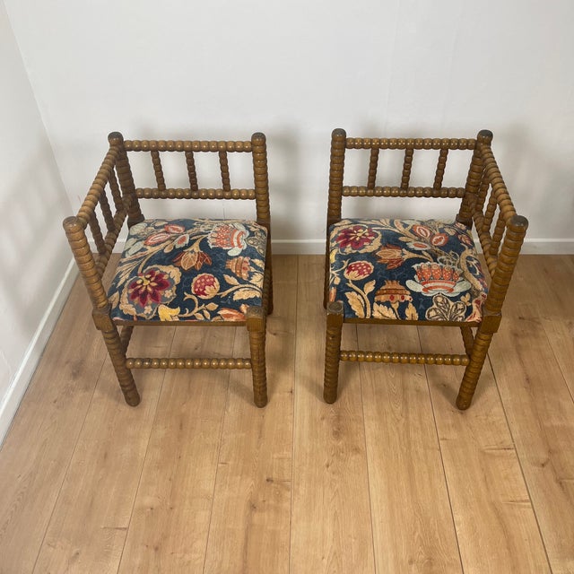 Pair of turned wood corner chairs with bobbins and fabric seats, mid-20th century Dimensions: 41 x 41 cm Total height: 64...