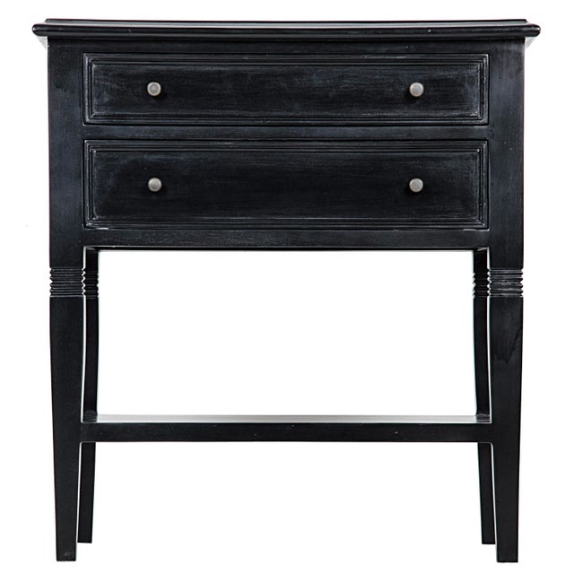 Intriguing design elements, like decorative carving atop tapered legs and two slim drawers, elevate the traditionally...