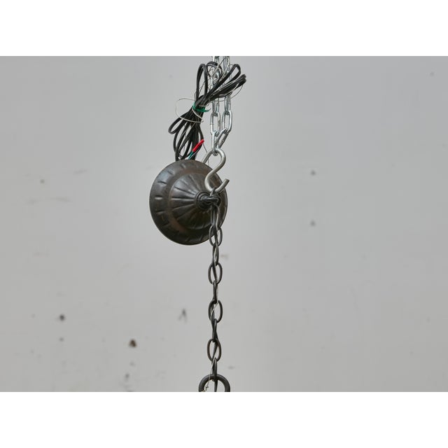 This antique French chandelier, crafted circa 1900, showcases the bold presence and lasting elegance of hand-forged...