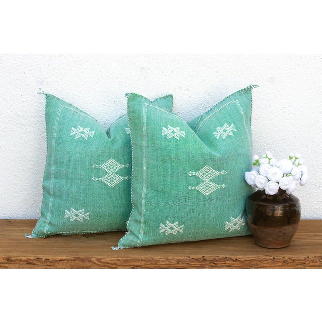 Sold as a matching pair, these handcrafted Moroccan cactus silk pillows feature scattered star motifs and a central...