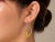 Striking 14K Two-Tone Gold Snake Loop Earrings accented with 0.20 carat diamonds. These elegant estate earrings feature a...