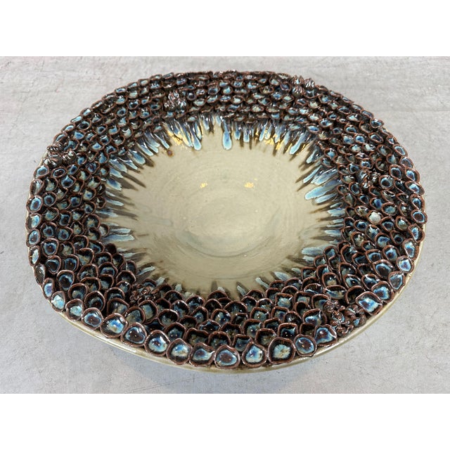 Large ceramic bowl with a whimsical "mushroom" rim and a green, brown, and blue glaze. Marked: Des Pots Holland. In...