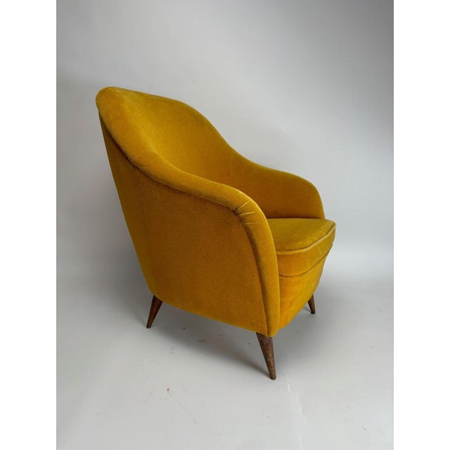 This mid-century Italian armchair, in the style of Gio Ponti, boasts a soft, enveloping organic shape with a high, curved...