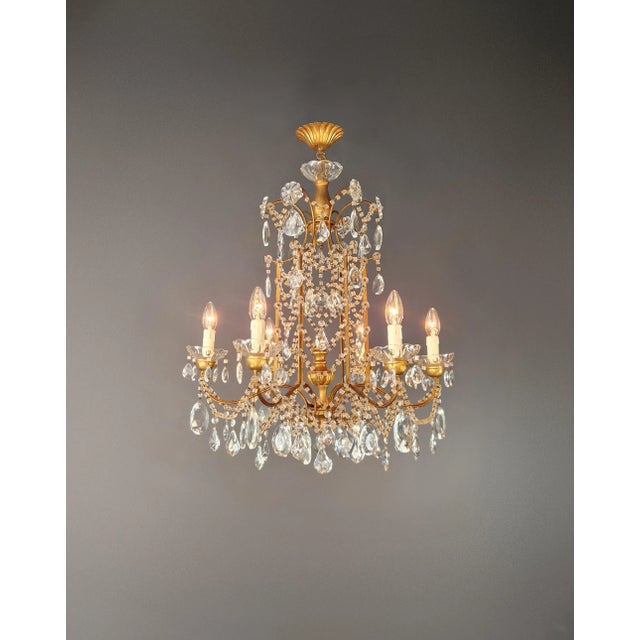 Restored Gilded Iron and Crystal Chandelier Italian Louis XVI Style, circa 1910 A beautifully restored chandelier from...