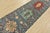 A tribal Caucasian Kazak runner hand-knotted with fine wool on a cotton foundation. This rug features a row of geometric...