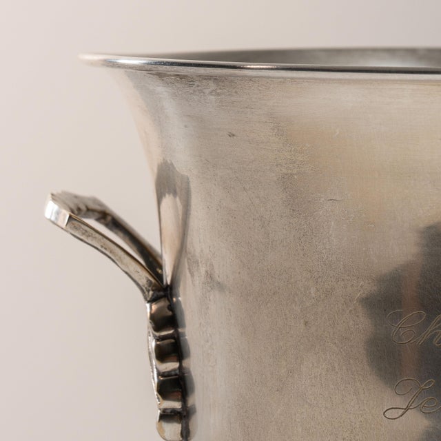 This mid 20th century ice bucket from France is finished in silver. It is engraved with the Jean Milan Oger wordmark, a...