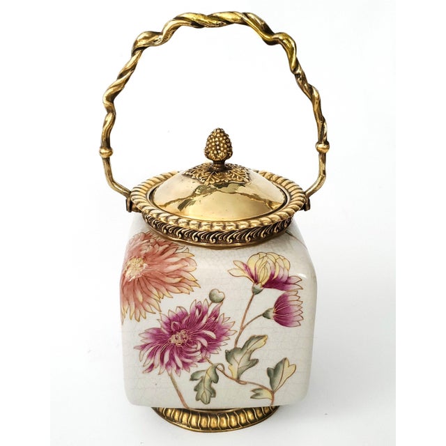 Offering a vintage Chinese porcelain Ginger Jar, Biscuit Jar or Tea Caddy with brass ormolu detailing, circa late 20th...