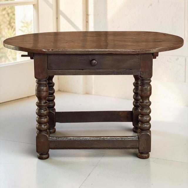 Fashioned from solid oak during the early 18th century, this French Louis XIII period table possesses the honest...