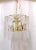 This is a vintage Murano chandelier with decorative triangular panels and gold plated frame. This light has 7 candelabra...
