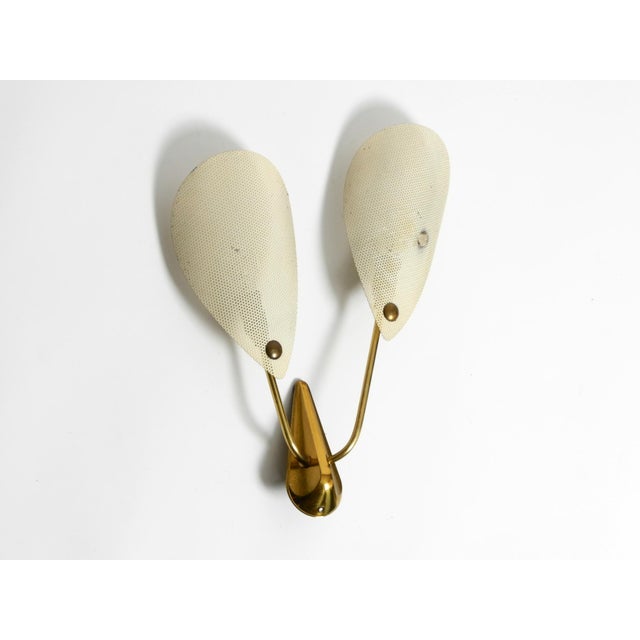 Beautiful 1950s brass wall lamp with two perforated metal lampshades. Typical Mid Century Modern design in original...