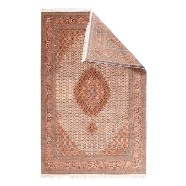 The ivory field of this impeccable neatly woven NW Persian urbane carpet presents a very small scale textile pattern...