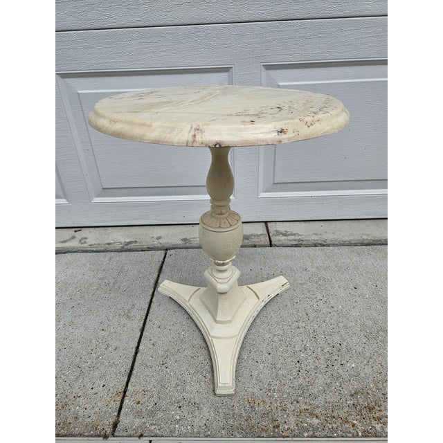 This off-white and cream faux marble top side table or plantstand has an antiqued appearance. The base and column are...