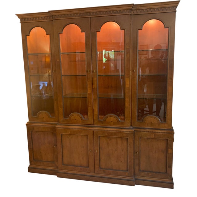 From the Henredon 18th Century Portfolio Collection, this is a superior vintage burl-walnut breakfront china cabinet....