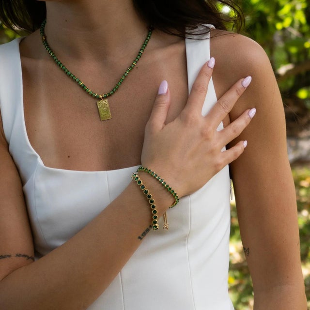 Illuminate your style with the Emerald Glow Adjustable Gold Bracelet, a refined piece designed to radiate elegance and...