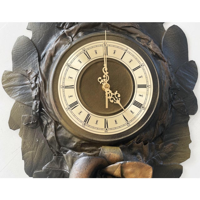 A unique, large wall clock made of genuine leather, molded into a decorative leaf and flower motif. This is no ordinary...