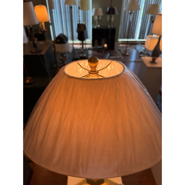 A Haig table lamp featuring a diamond-shaped brass-plated antique nickel column accented by solid brass detailing and a...