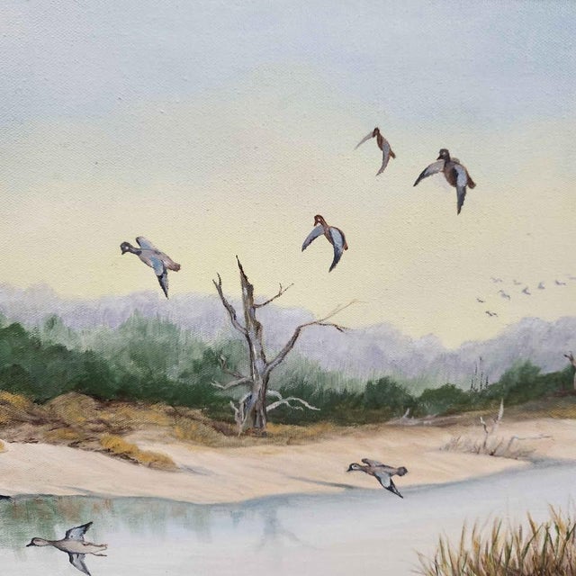A signed vintage coastal marsh landscape painting by Gladys Spence, presented in an elegant carved gilt wood frame with a...