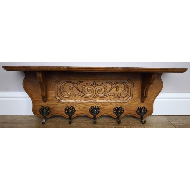 A charming Vintage French coat hanger featuring elegant carved detailing and a warm oak finish that adds character to any...