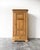 Late 19th c. antique European pine knockdown wardrobe featuring a single paneled door, original garment hooks inside, one...