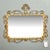 Mid century Italian mirror framed in a scrolled iron frame with a tall crest and gilded finish. Circa 1960s. Excellent...