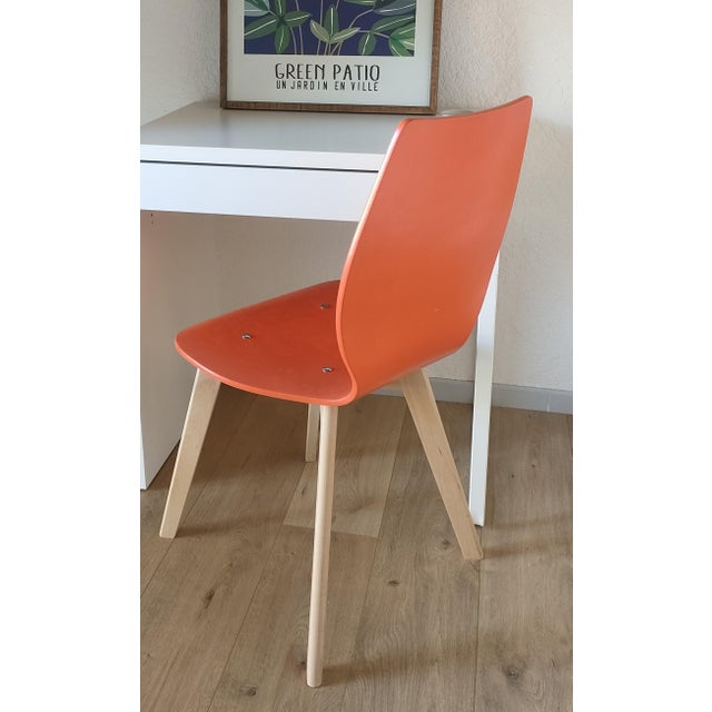 Scandinavian-style office chair, seat in thermally modified beech wood, orange in color (painted during renovation). Base...