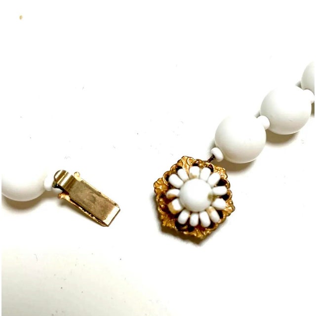 A lovely example of midcentury American costume jewelry, this vintage Miriam Haskell necklace pairs luminous white glass...