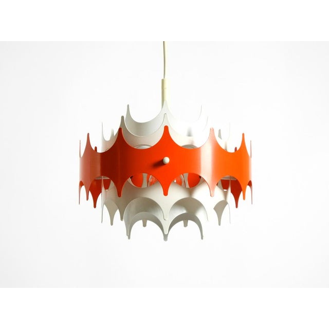 Beautiful, small, original 1960s Space Age metal pendant lamp by Doria. The outer shade is red; the rest of the shade is...