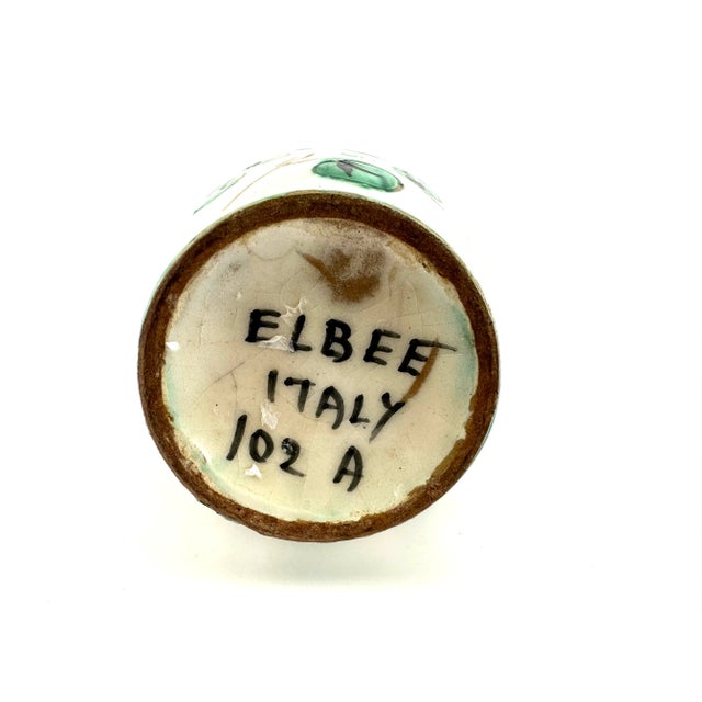 I simply love this piece! The small pottery piece has vibrant hand painted colors of yellow, blues and greens. Floral...