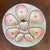 This antique Carl Tielsch porcelain oyster plate features distinctive pink luster wells and a central shell motif, dating...