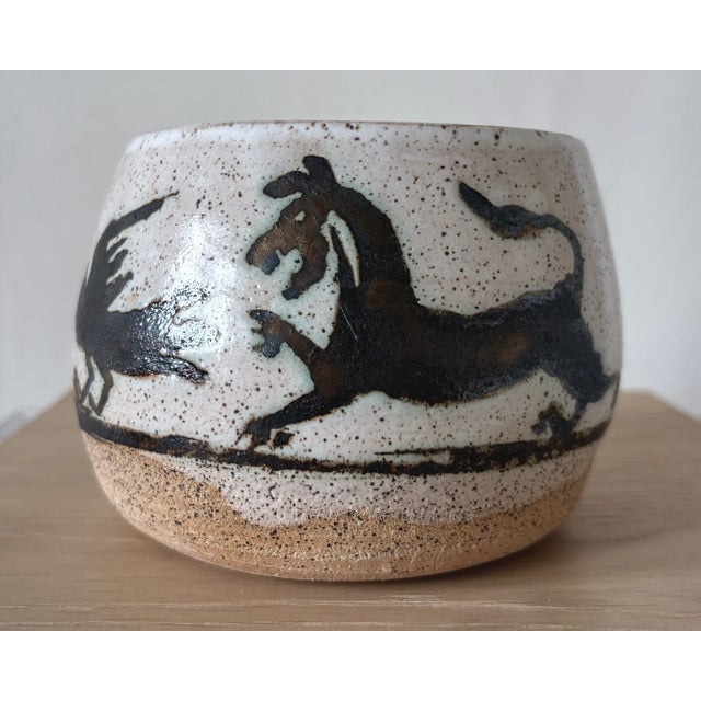 A highly expressive American studio pottery vessel from New York, decorated with a continuous procession of stylized...