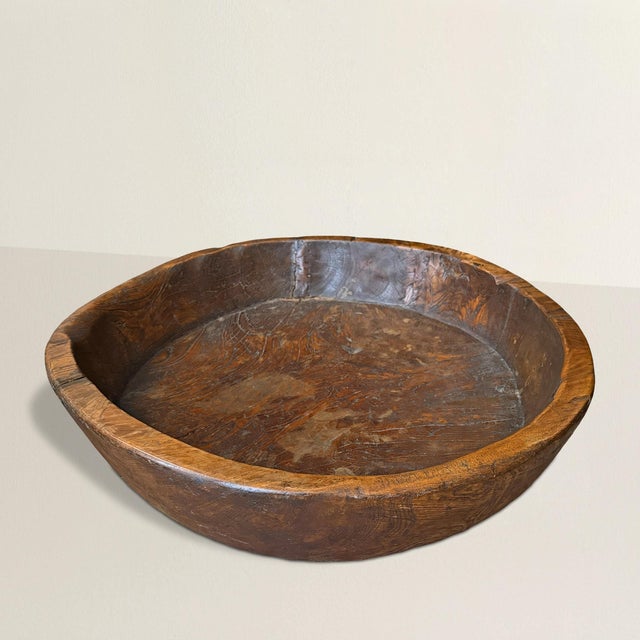 Scale is the first impression. At over thirty inches in diameter, this 19th to early 20th century burl wood bowl commands...