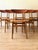 A beautifully restored set of six Danish Farstrup Model 210 dining chairs, crafted in solid beech with sculptural teak...