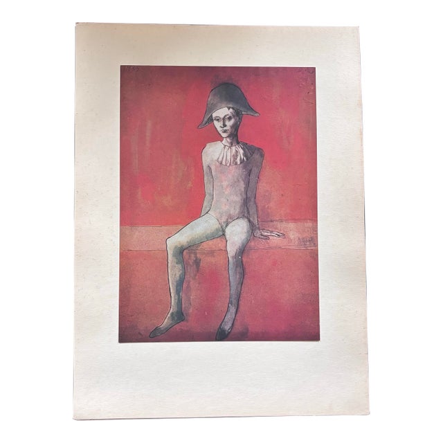 After Pablo Picasso, Seated Harlequin Boy With Red Background. Limited Edition Chromolithograph Printed in Switzerland by Skira in the 1940s For Sale