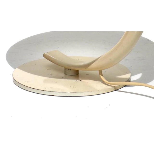 This table lamp features a structure in ivory painted metal and an internally frosted glass diffuser. European Plug (up to...