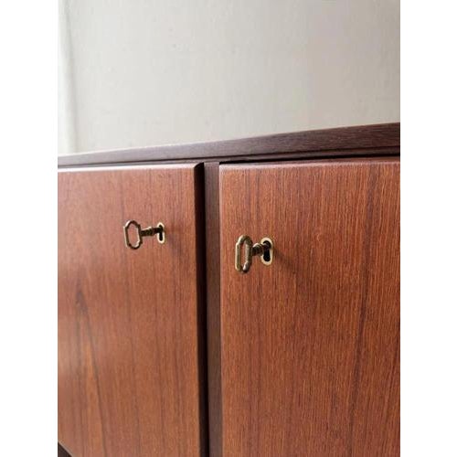 This spacious sideboard from the 1960s stands out due to the serene proportion between the long cabinet body and the...