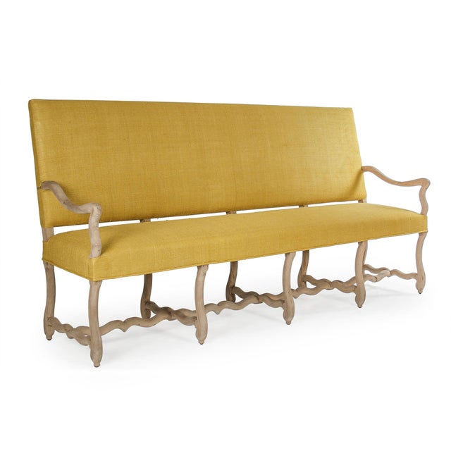 The Veronike Bench from Zentique is a dramatic 90" wide upholstered hall bench with a tall straight back in yellow raw...