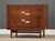 A mid century modern walnut three drawer dresser with aluminum x inlay and aluminum drawer pulls made by American of...